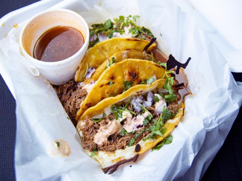 Photo of birria tacos with cheese and dipping consomme