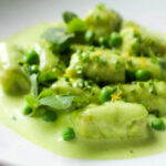 A plate of sweet pea gnocchi in a cream sauce