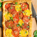 A photo of re and yellow tomato tart