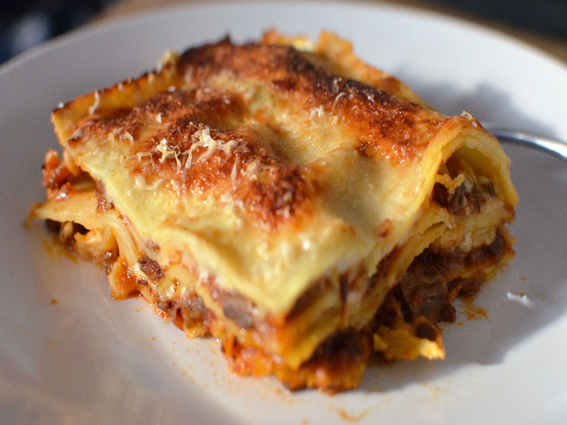 A photo of a plate of lasagne bologonese