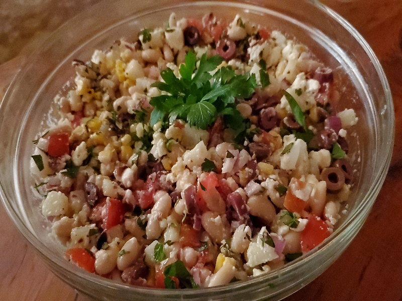 A bowl of Peruvian dish solterito - beans, corn, tomatoes, red onion and cheese