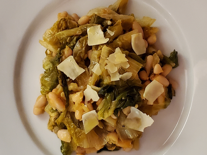 A photo of a plate of braised escarole & cannellini beans